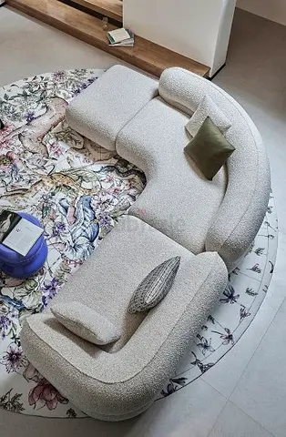 Cozy Curved Sofa with Unique Floral Rug