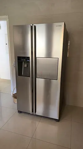 Daewoo side by side refrigerator with a water/ice dispenser and a mini-bar feature.