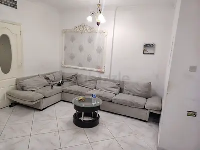 Comfortable L-Shaped Grey Sofa with Glass Coffee Table