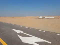 Commercial land for sale in Sharjah, Rawdat Al Qurt area, Al Ruwaidat suburb.