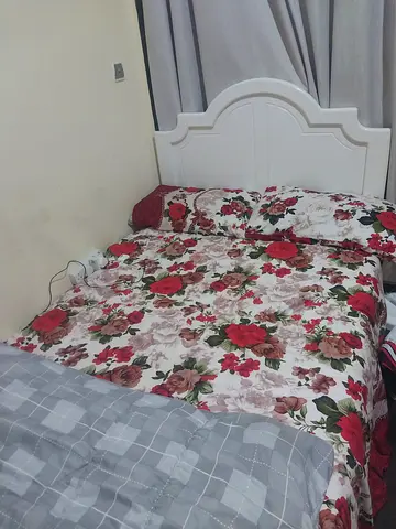 A bed with clean mattress and a cabinet.  Complet set