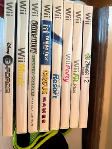 Nintendo Wii with a Collection of Wii Games including Action and Fitness Titles, with balance.