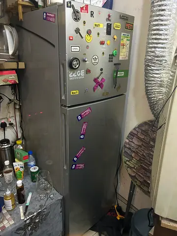 Reliable Silver Refrigerator with Fun Stickers
