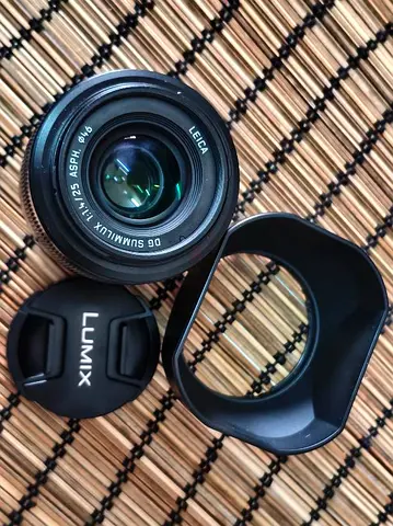 Lumix Leica 25mm f1.4 Lens with Hood and Cap - Perfect for Your Photography Needs!