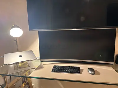 Sleek Ultrawide Monitor with Stand and Accessories powered by MacBook