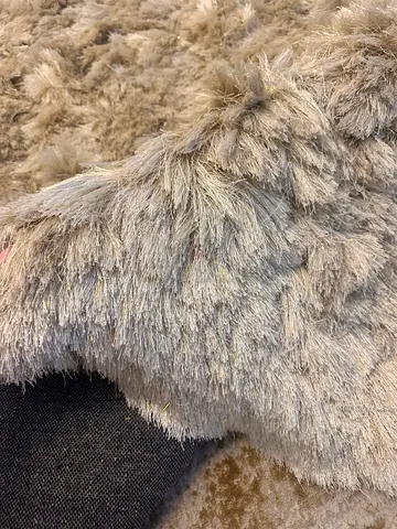 Beige carpet with long pile, shiny, size 140 x 200.