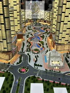 Own a fully furnished two-bedroom apartment with a living room in the Tiger Downtown Ajman project w