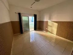 A spacious one-bedroom apartment for sale in Orient Towers,, features a balcony with an open garden