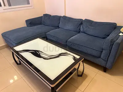 Comfortable Blue Sofa and Stylish Glass Coffee Table for Sale