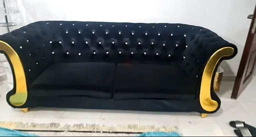 Luxurious Black Velvet Sofa with Golden Accents