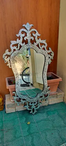 Elegant Ornate Mirror with Reflective Design