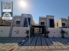 Luxury villa for sale in Al Rawda 3, Ajman. 5 master bedrooms, living room, majlis, kitchen, and mai