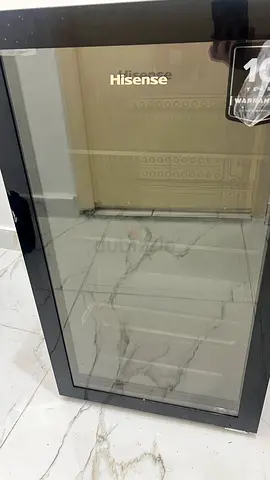 A brand-new Hisense refrigerator, still under warranty, for sale for 300 AED.