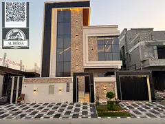 For sale in Al Yasmin, a two-story villa with a roof terrace, featuring 5 master bedrooms, a majlis,