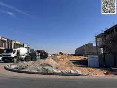 Land for sale in Ajman, Al Helio 2 area, including fees. Residential villas. Corner plot on two pave