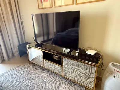 Elegant Mirrored Entertainment Center with Gold Accents. Tv not included. Good storage