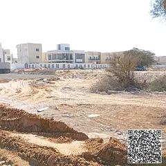 Two plots of land on a wide road and alley, priced below the market and close to Al Zahia Street.