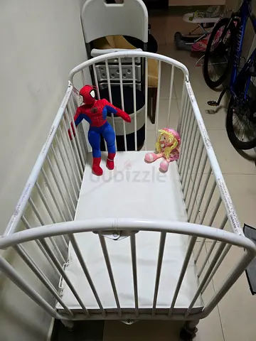 Spacious Baby Crib with Playful Plush Toys