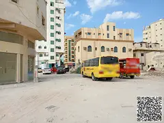 Residential–commercial plot near Ajman Walkway, located on a street and alley, third plot from the