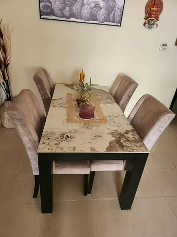 Elegant Ceramic top Dining Table with Plush Chairs