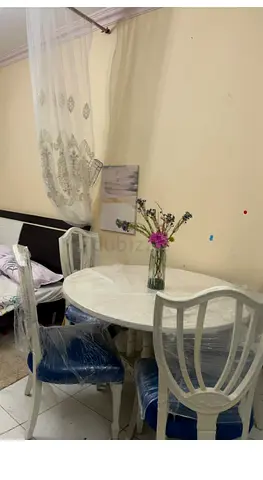 Elegant Round Dining Table Set with Chic Blue Chairs