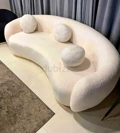 Elegant Curved Sofa with Decorative Cushions