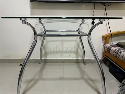 Stainless steel frame with a durable glass top dining table