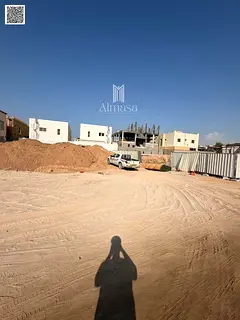 Prime land for sale in Al Zahia, Ajman, on a main road and alley.