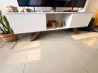 Modern White TV Stand with Stylish Wooden Legs purchased in June from PAN homes, in new condition.