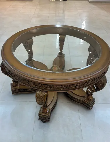 Elegant Round Glass Coffee Table with Intricate Carvings