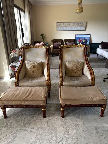 Luxurious wooden white-golden chairs with foot-benches