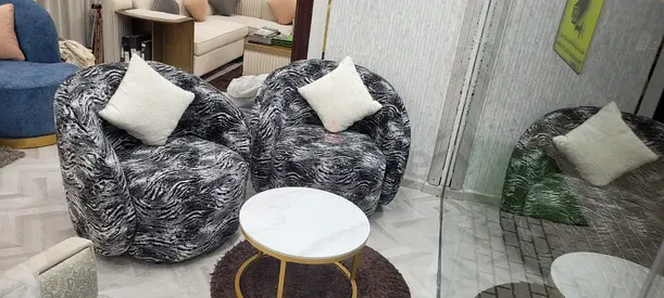 Comfortable Modern Lounge Chairs with Cozy Pillows and round shape Table
