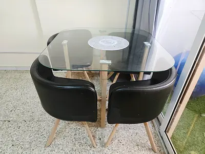 Stylish Glass Dining Table with Black Chairs