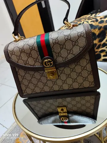 Gucci Monogrammed Handbag with Iconic Stripes