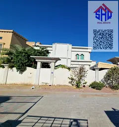 Villa for sale in Al Muwaihat area, near a mosque. Includes water, electricity, and air conditioning