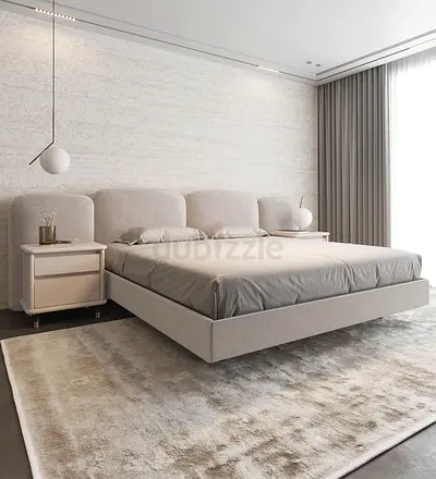 Double bed with upholstered headboard and suspended base.