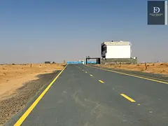 Own a ready-to-build residential plot on a corner lot with two street frontages in Sharjah.