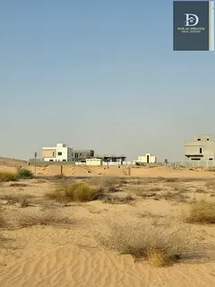 For sale in Sharjah - Corner plot on two streets, 24 meters each - Rawdat Al Qurt - opposite Al Suyo