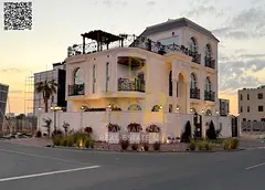 Luxury corner villa for sale in Al Bahia, Ajman | Two floors + roof | 5 master bedrooms | Majlis + l