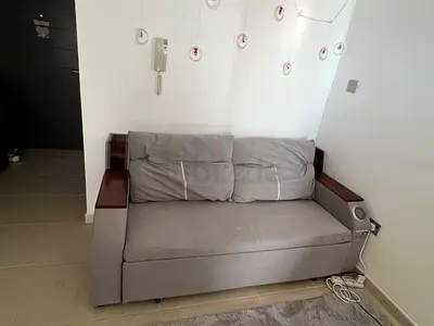 Cozy Grey Sofa Bed with Wooden Accents, Bluetooth and speakers