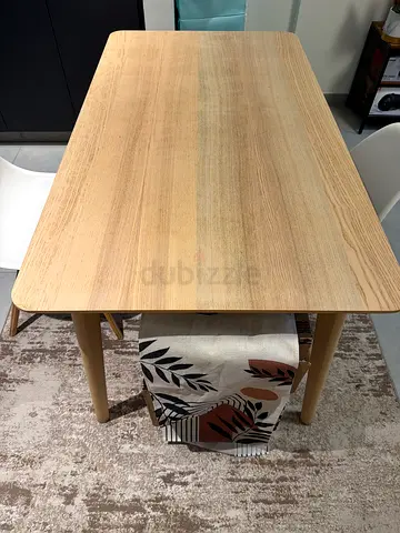 Stylish Wooden Dining Table with Unique Patterned Chairs