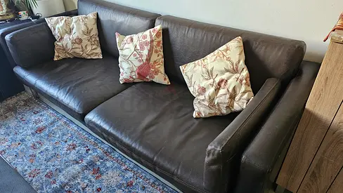 Comfortable Leather Sofa with Elegant Floral Cushions