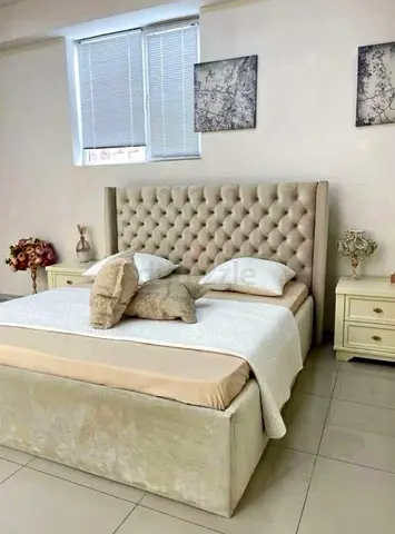 Elegant Bed with Plush Headboard and Storage