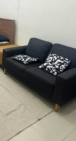 Comfortable Dark Grey Two-Seater Sofa with Decorative Cushions