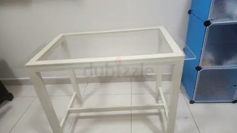 Minimalist white study desk featuring a spacious rectangular tabletop and sturdy fixed support legs.