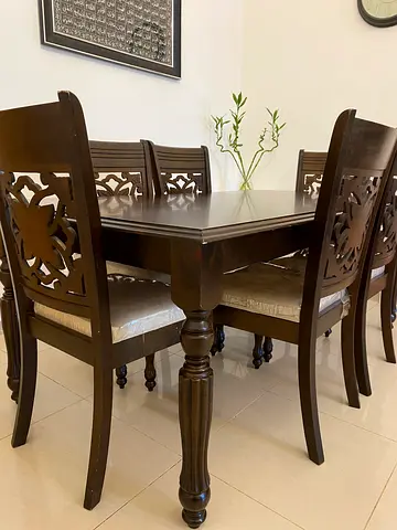 Beautiful Dark Wood Dining Table with Intricate Design