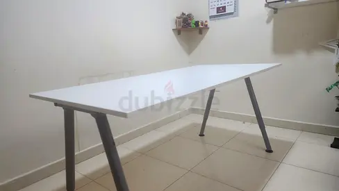 Clean white IKEA-style study desk with height-adjustable grey legs. Sturdy, minimalist design