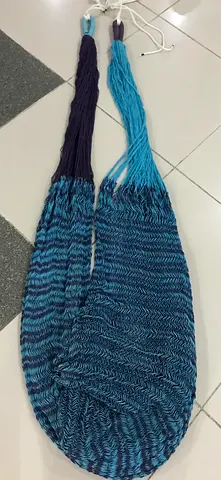This item is a Mexican or Brazilian-style woven cotton hammock with a striped blue and purple patter