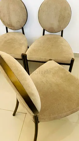 Eichholtz Scribe dining chair in greige velvet upholstery with a dark brass frame.