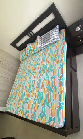 Comfortable Wooden bed with mattress.